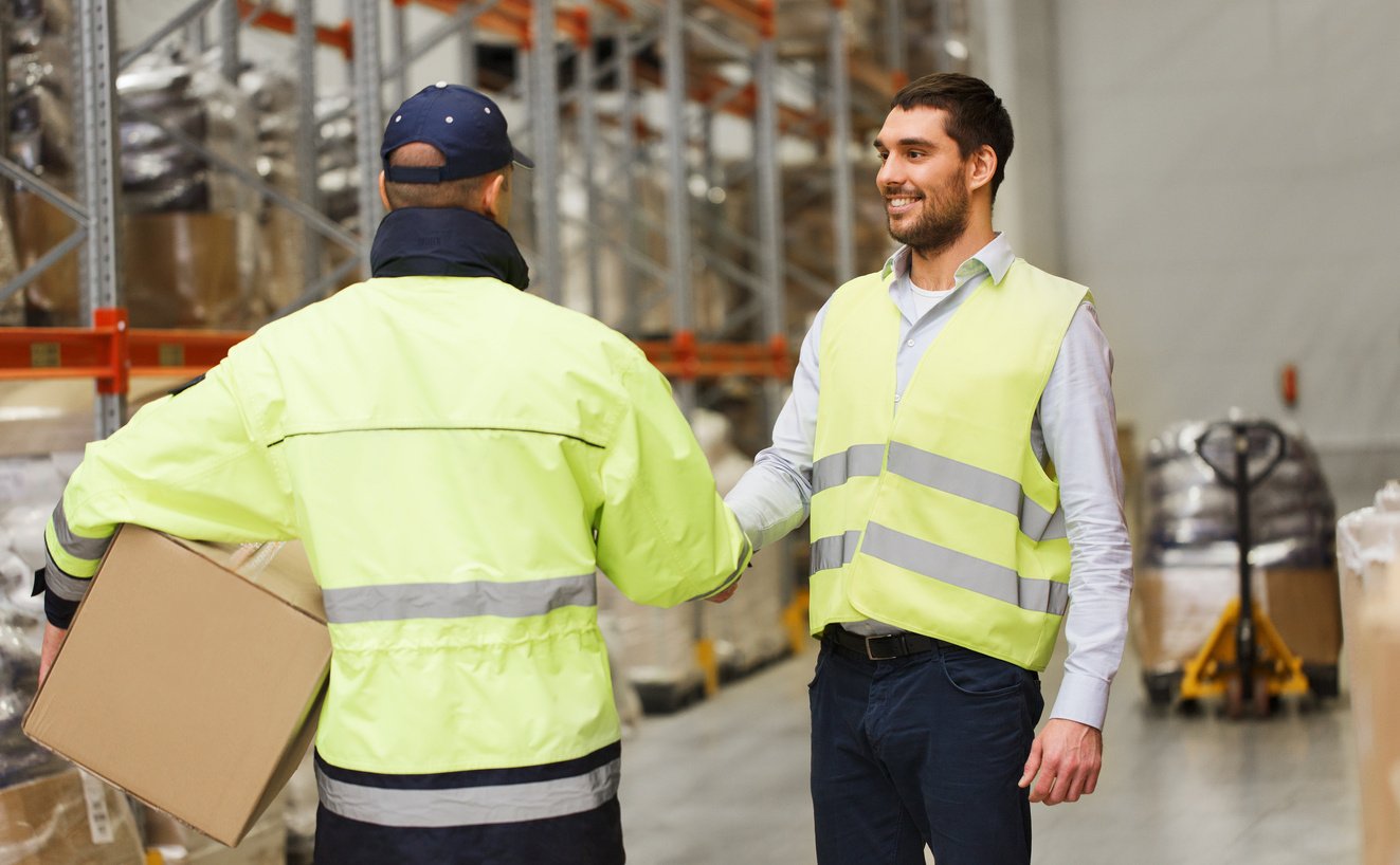 Men in Safety Vests Shaking Hands 